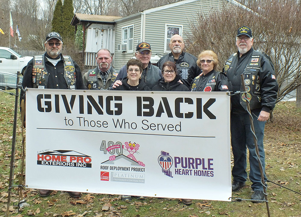 A coordinated effort by Rolling Thunder, Home Pro Exteriors and Owens Corning put a new roof on the home of Navy Veteran Raymond and his wife Denise Thompson in Highland. Pictured L-R Pete Szulewski, Ron Dibble, homeowners Denise and Raymond Thompson, daughter Gina Iudica, Charley Alonge, Sue and Ron Orts.